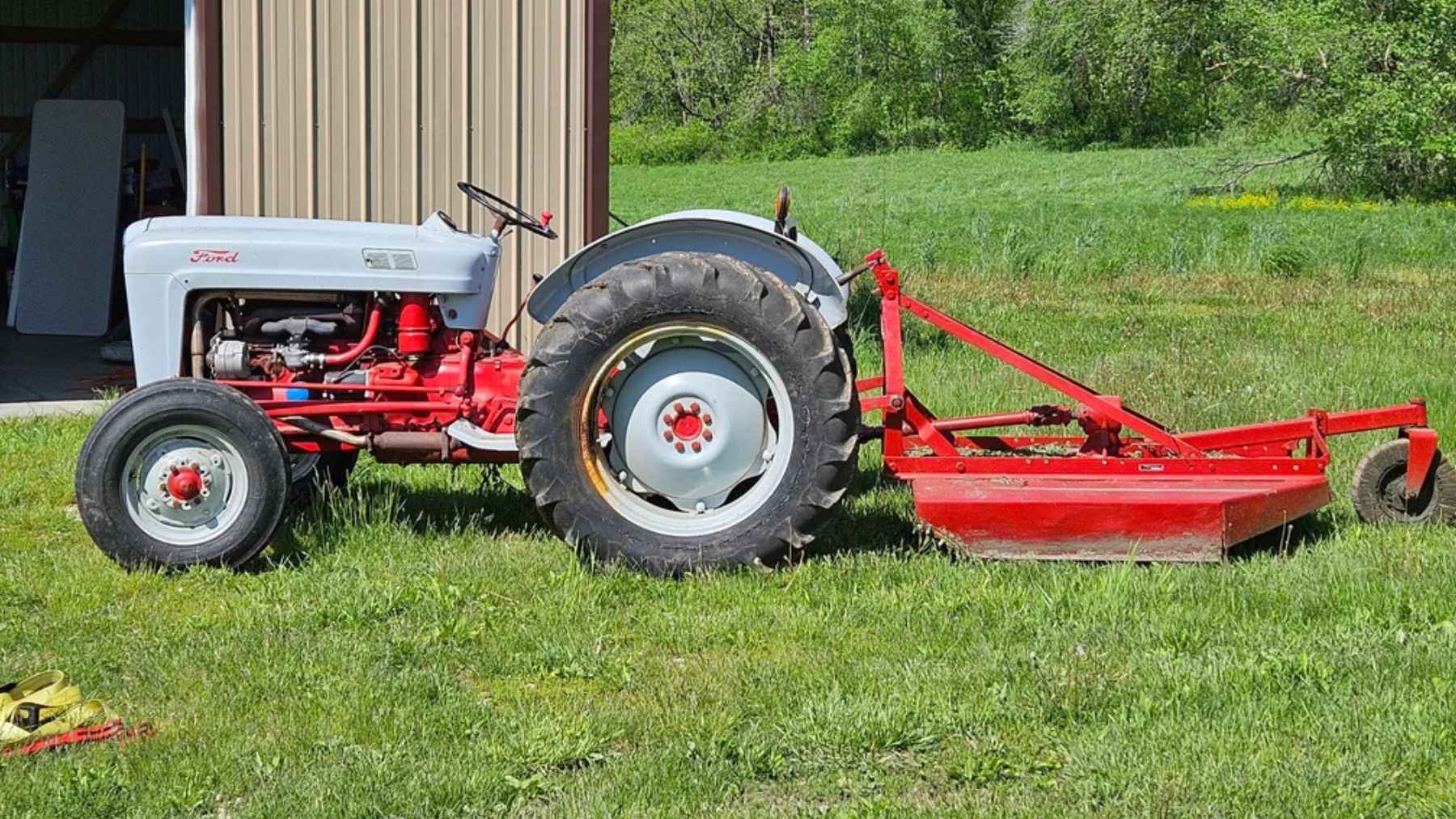 restored 1957 Ford 640 tractor with visible worn patch on fender preserved as a family handprint