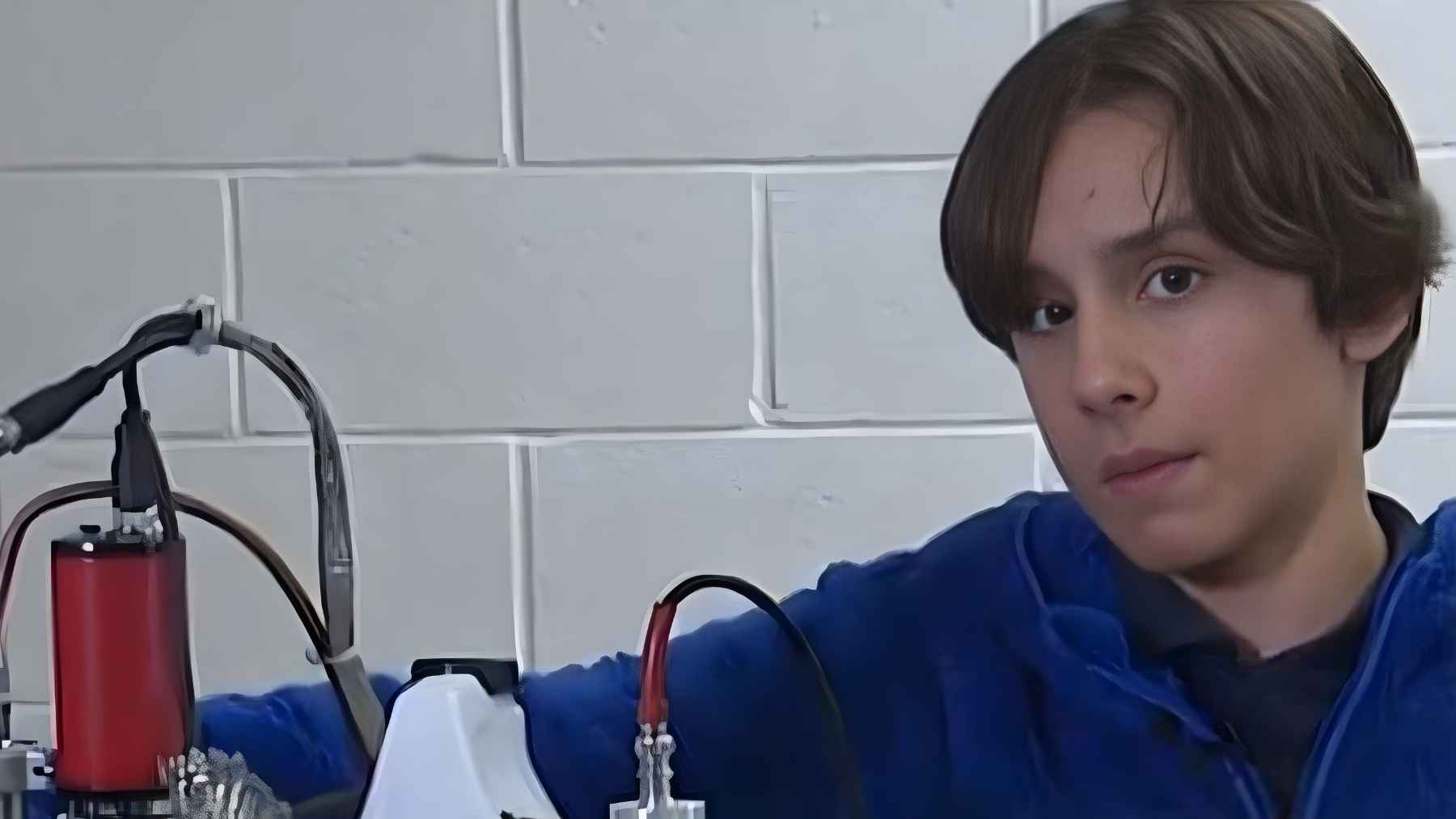 Aiden McMillan standing beside his homemade fusion reactor experiment designed to generate measurable neutrons.