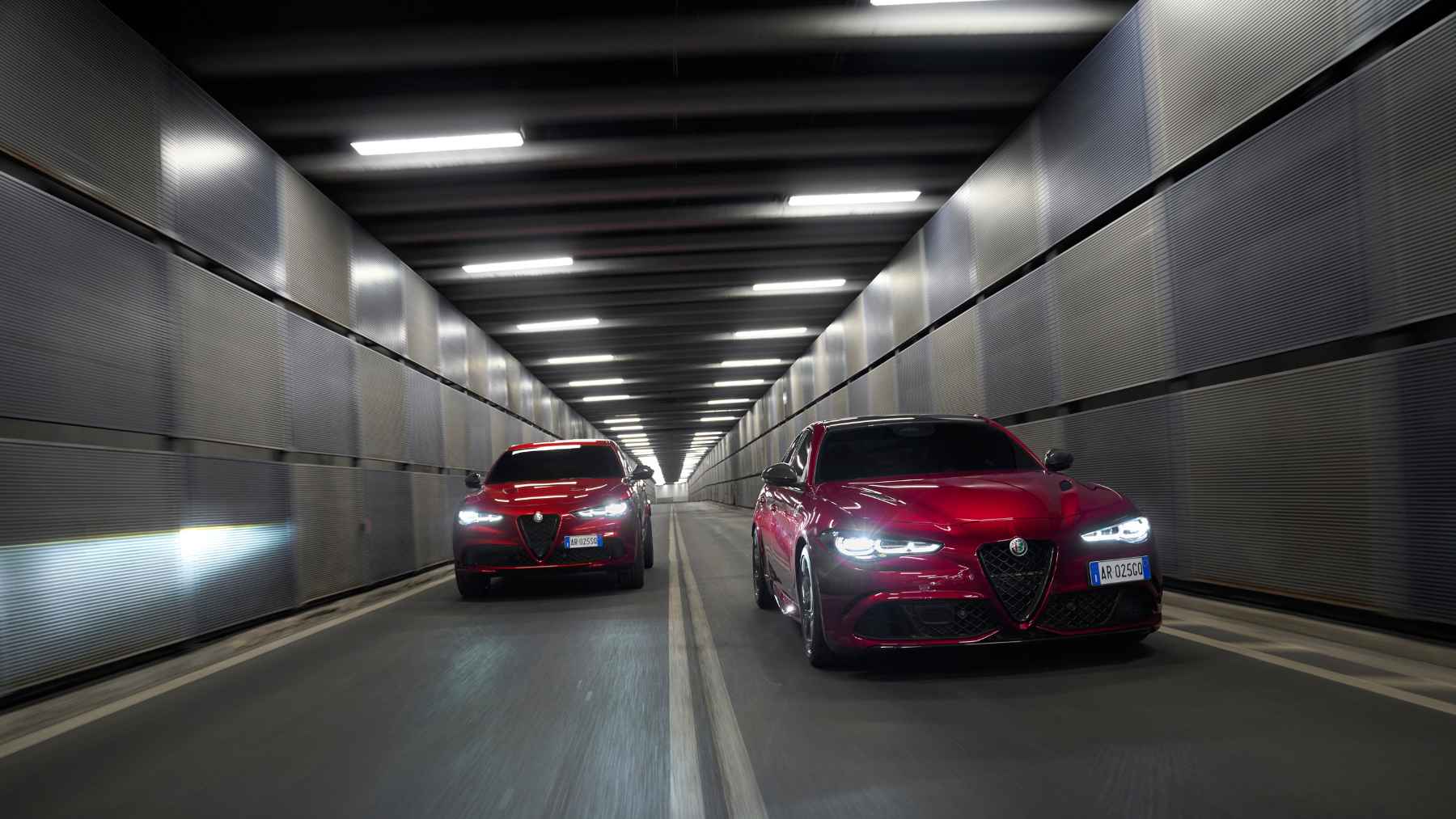 Alfa Romeo Giulia and Stelvio Quadrifoglio models driving through a tunnel, illustrating the return of the 520-horsepower gasoline V6 in Europe