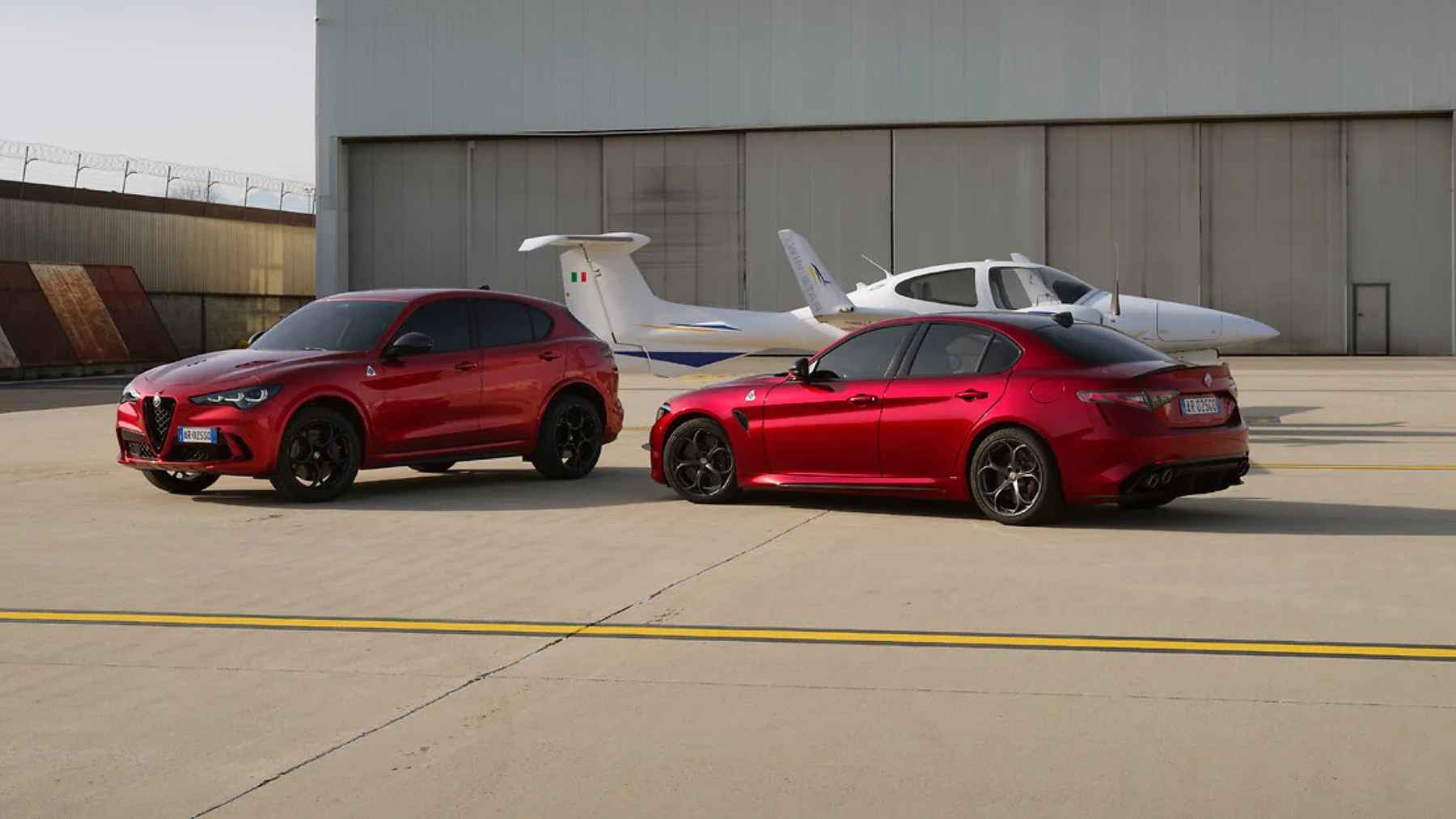 Alfa Romeo Giulia and Stelvio Quadrifoglio models parked on runway with high performance gasoline engines