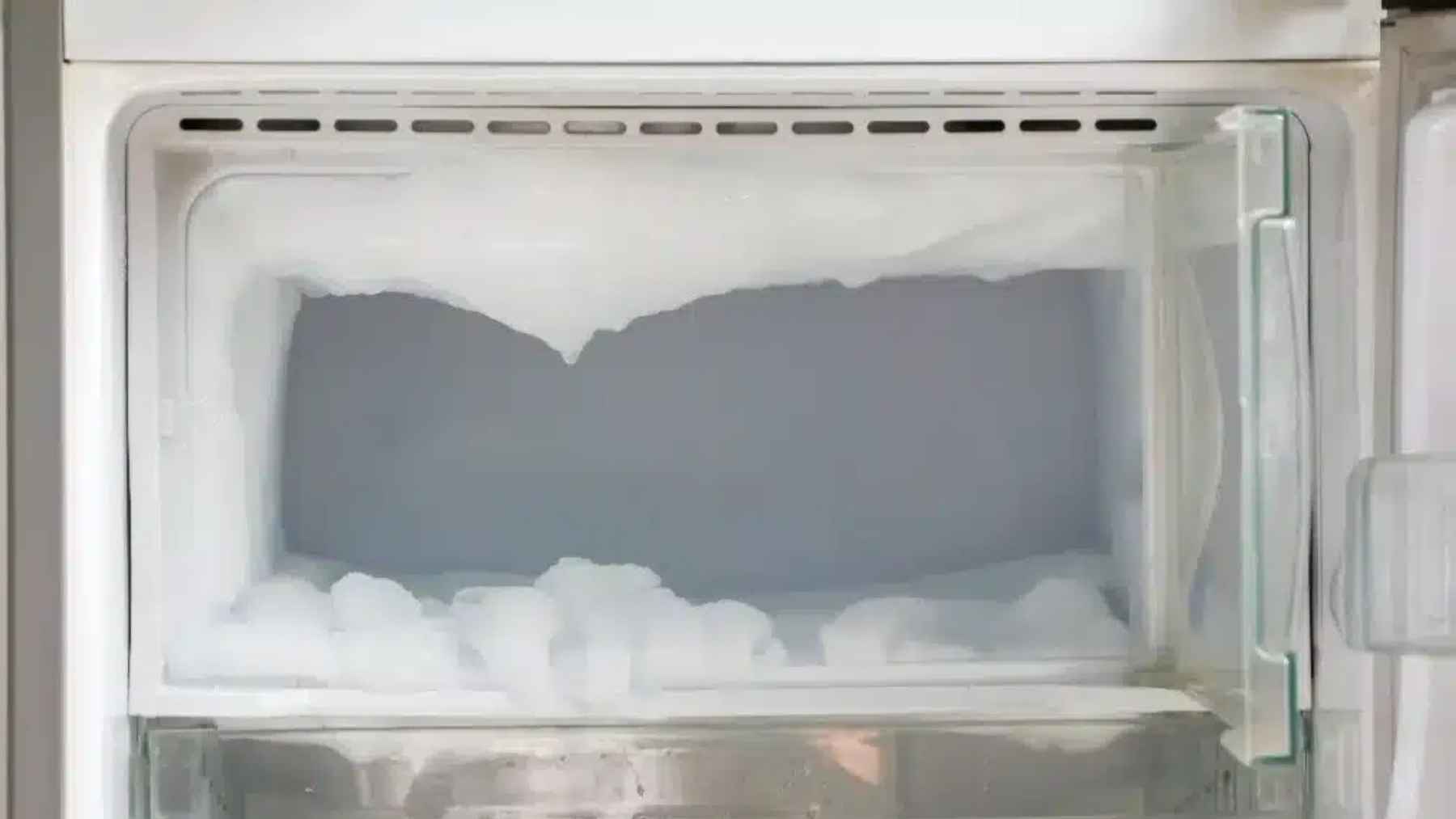 Aluminum foil lining a frost covered freezer wall to speed up ice removal during manual defrosting.