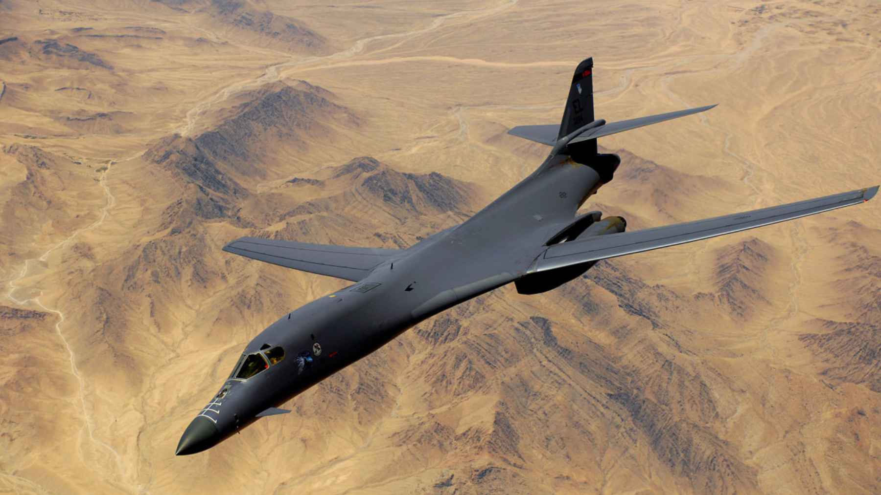 U.S. Air Force B-1B Lancer bomber flying over desert terrain during long-range strike operations linked to the Iran campaign