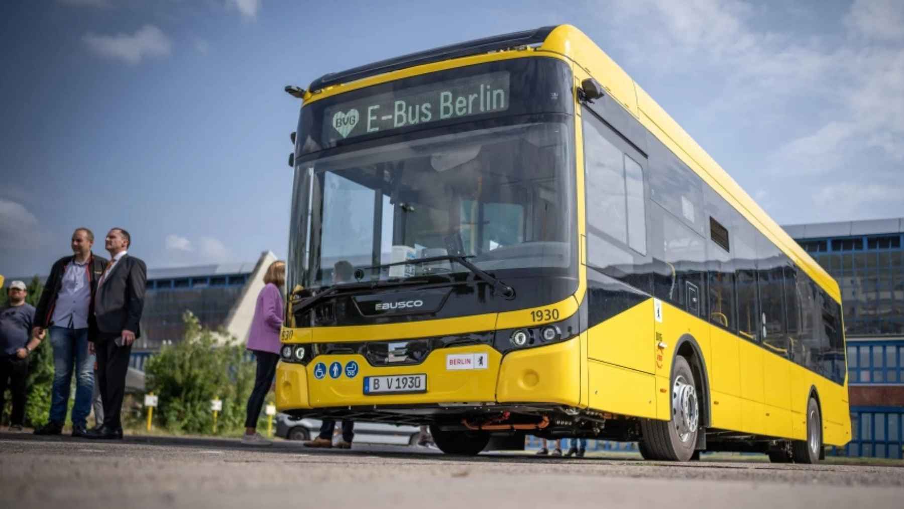 Yellow electric bus labeled E Bus Berlin parked in an urban setting in Germany