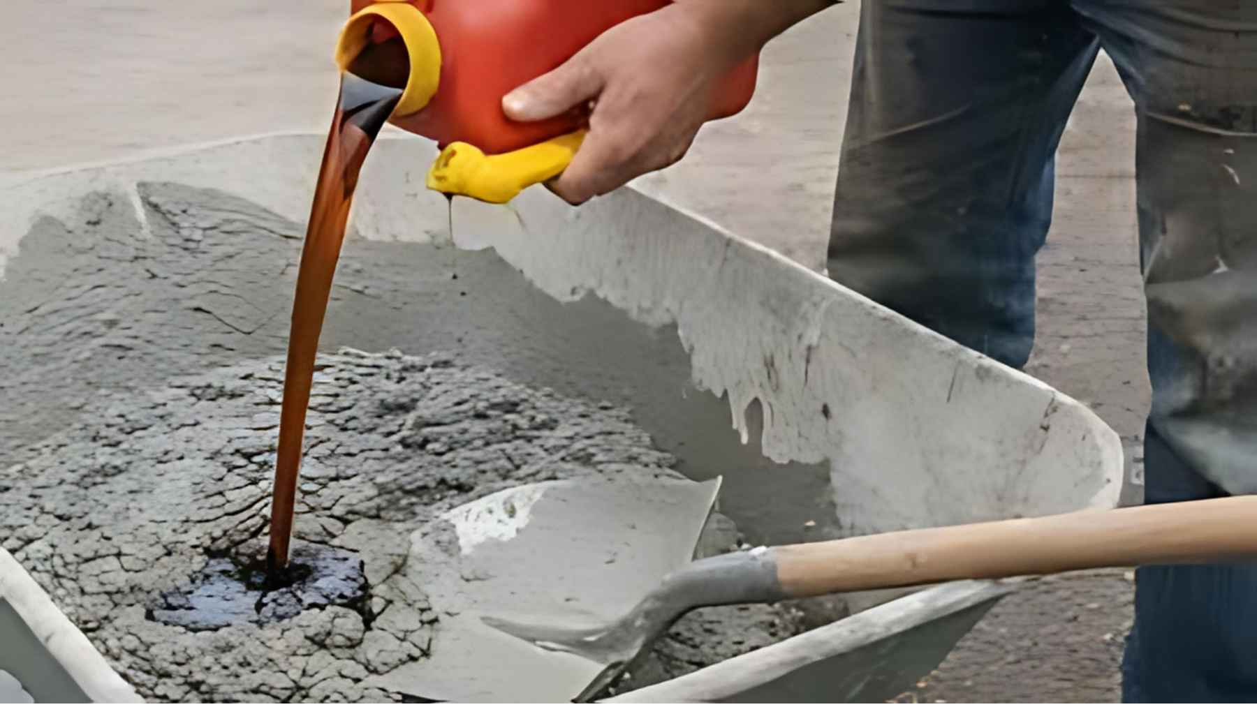 Worker applying cement mixture to seal cracks in a concrete wall during a waterproofing repair project.