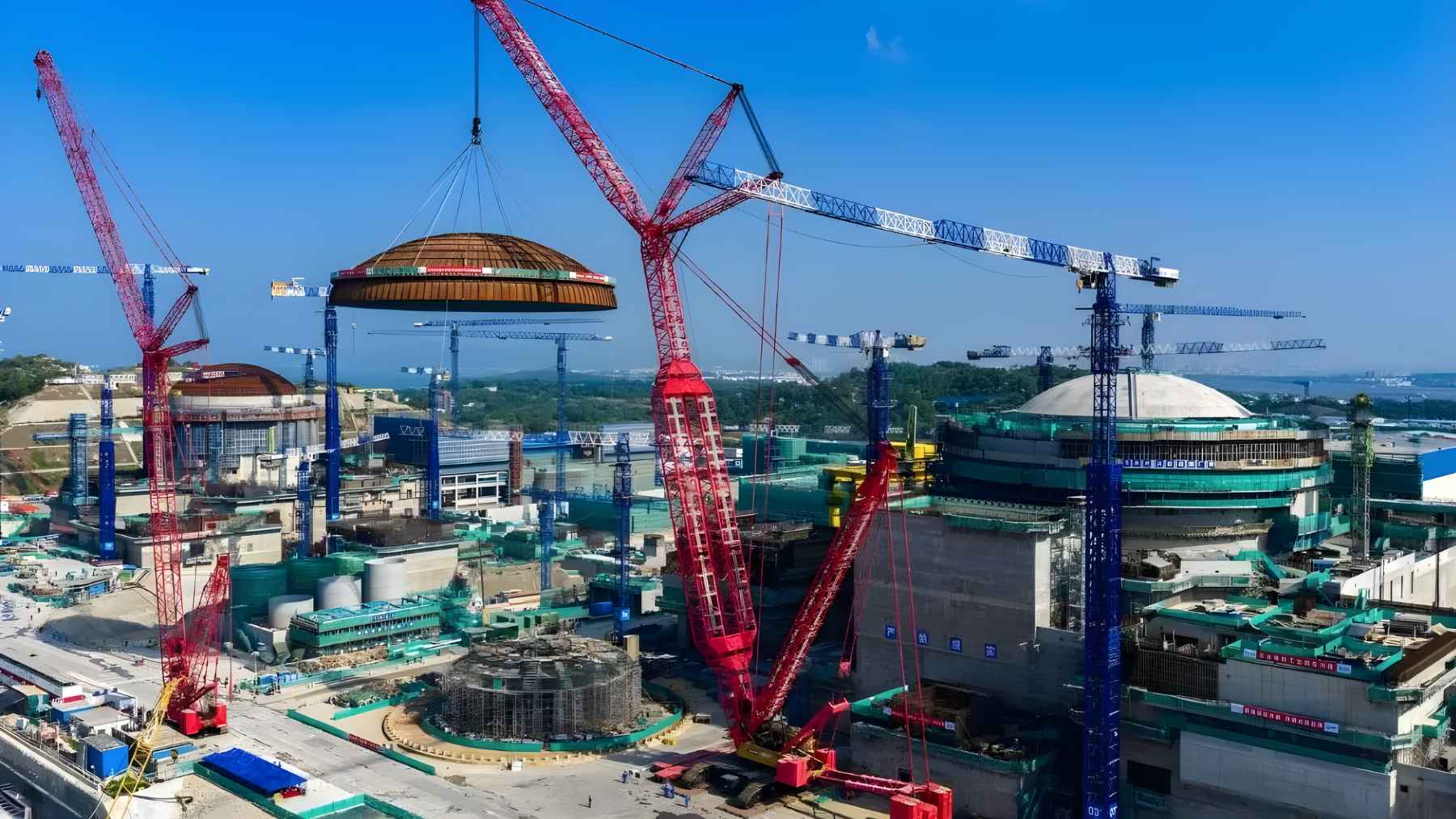 Massive steel dome being lifted into place at a nuclear power plant construction site in China