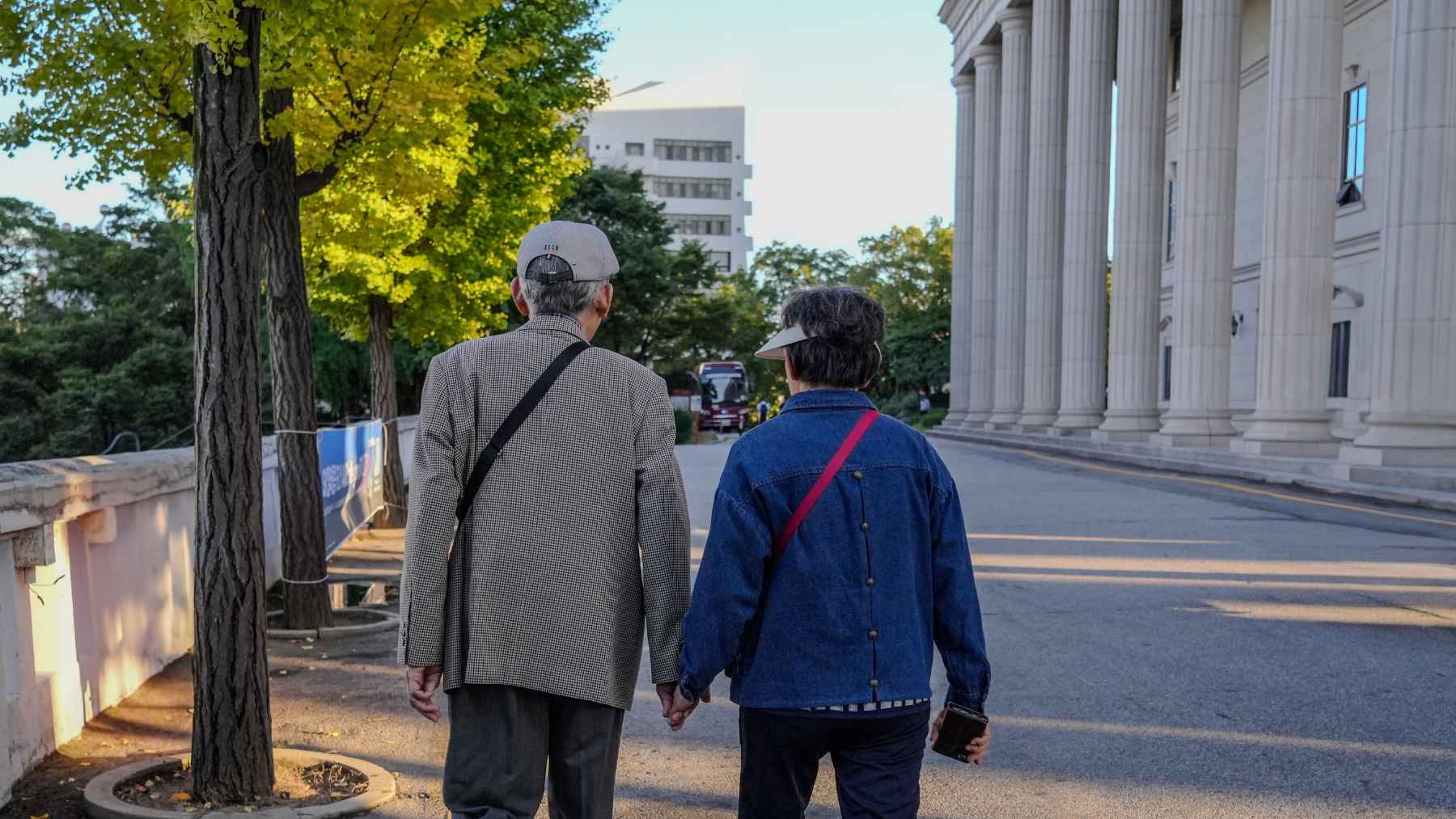 Older adult reviewing bills and expenses at home, highlighting the gap between pension income and living costs in Europe.