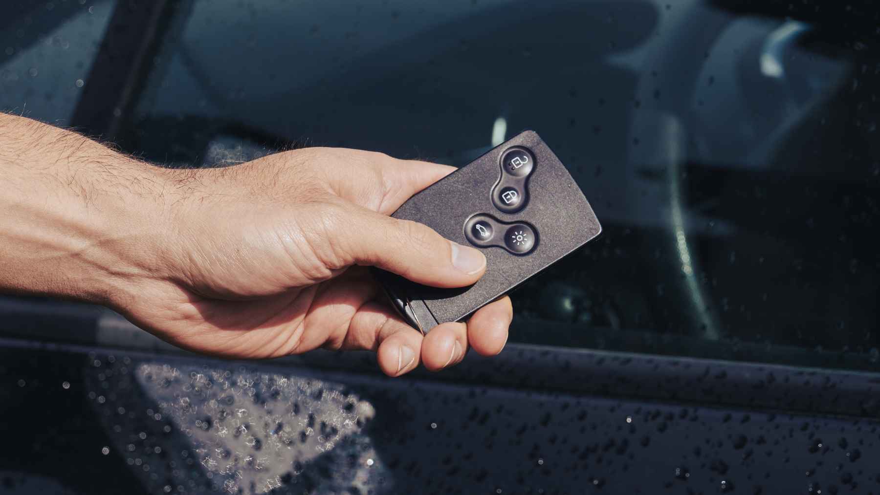 Car key fob wrapped in aluminum foil to block relay attack signals and prevent keyless vehicle theft