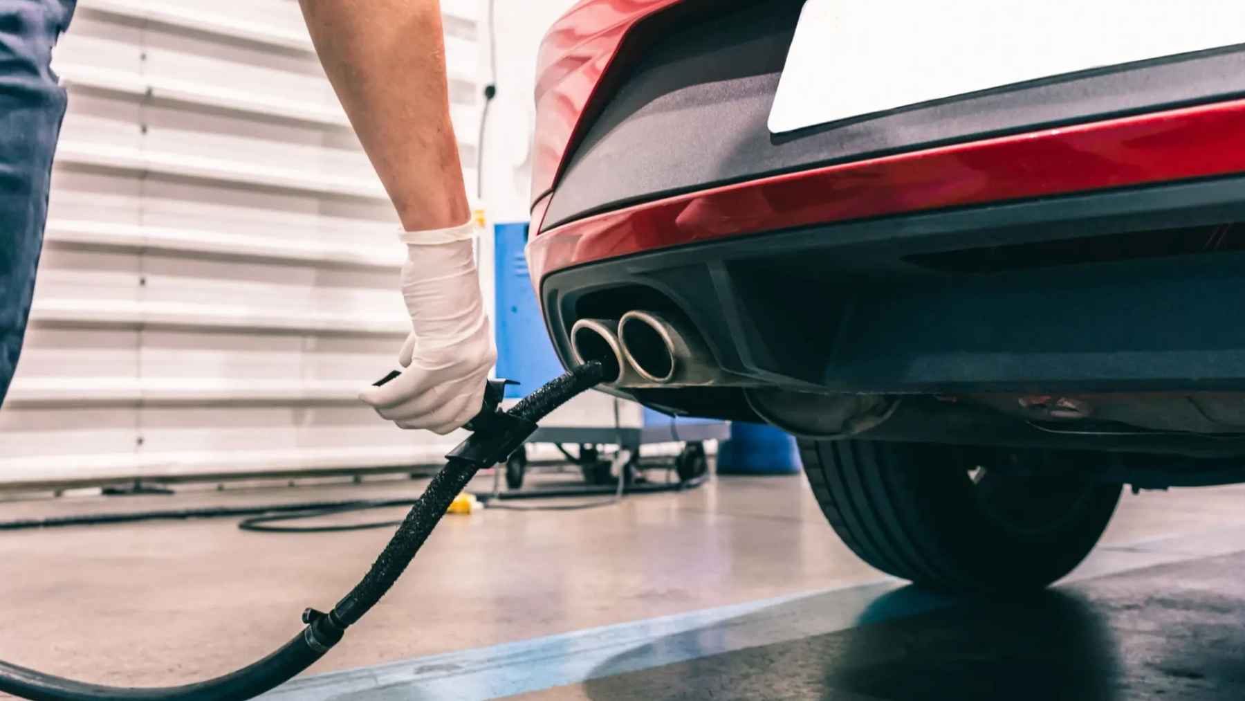 Driver fueling a car as rising gasoline prices push consumers toward electric vehicles and hybrids