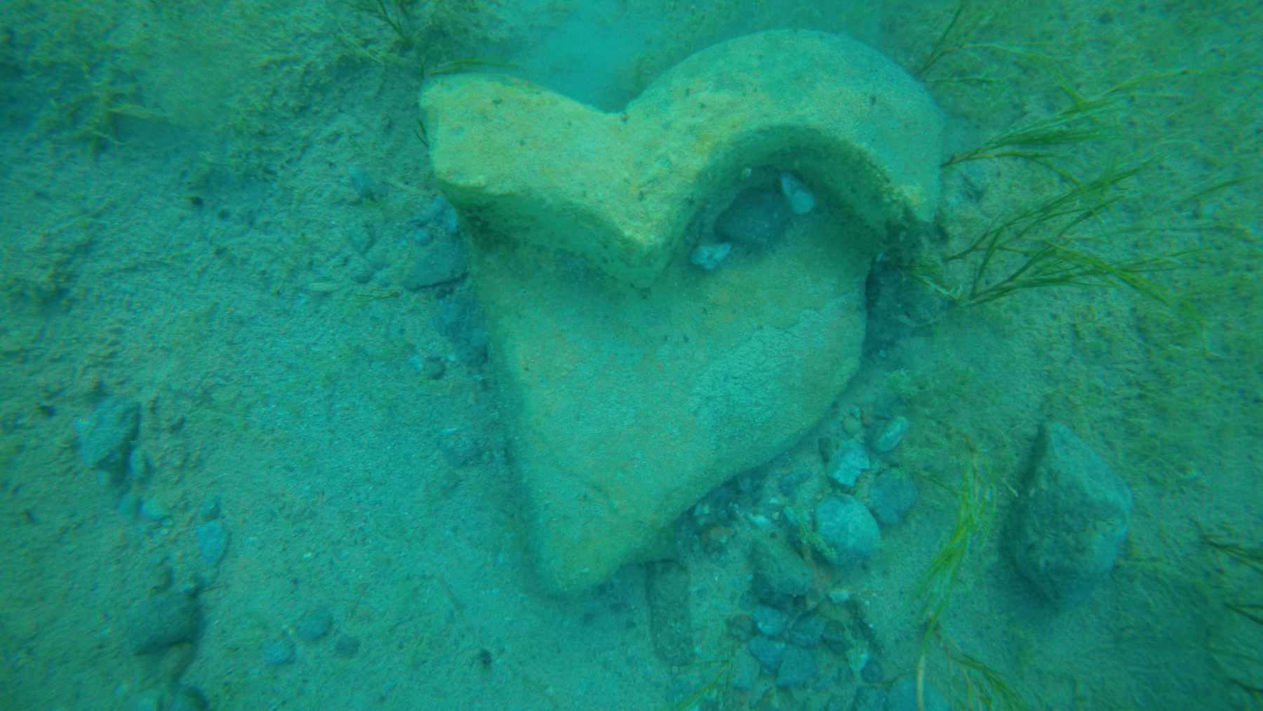 Robots explore a lake in Kyrgyzstan and discover a submerged medieval city with bricks, a necropolis, and intact structures 2 Ancient ceramic vessel partially buried in the lakebed of Lake Issyk-Kul during underwater archaeological exploration.