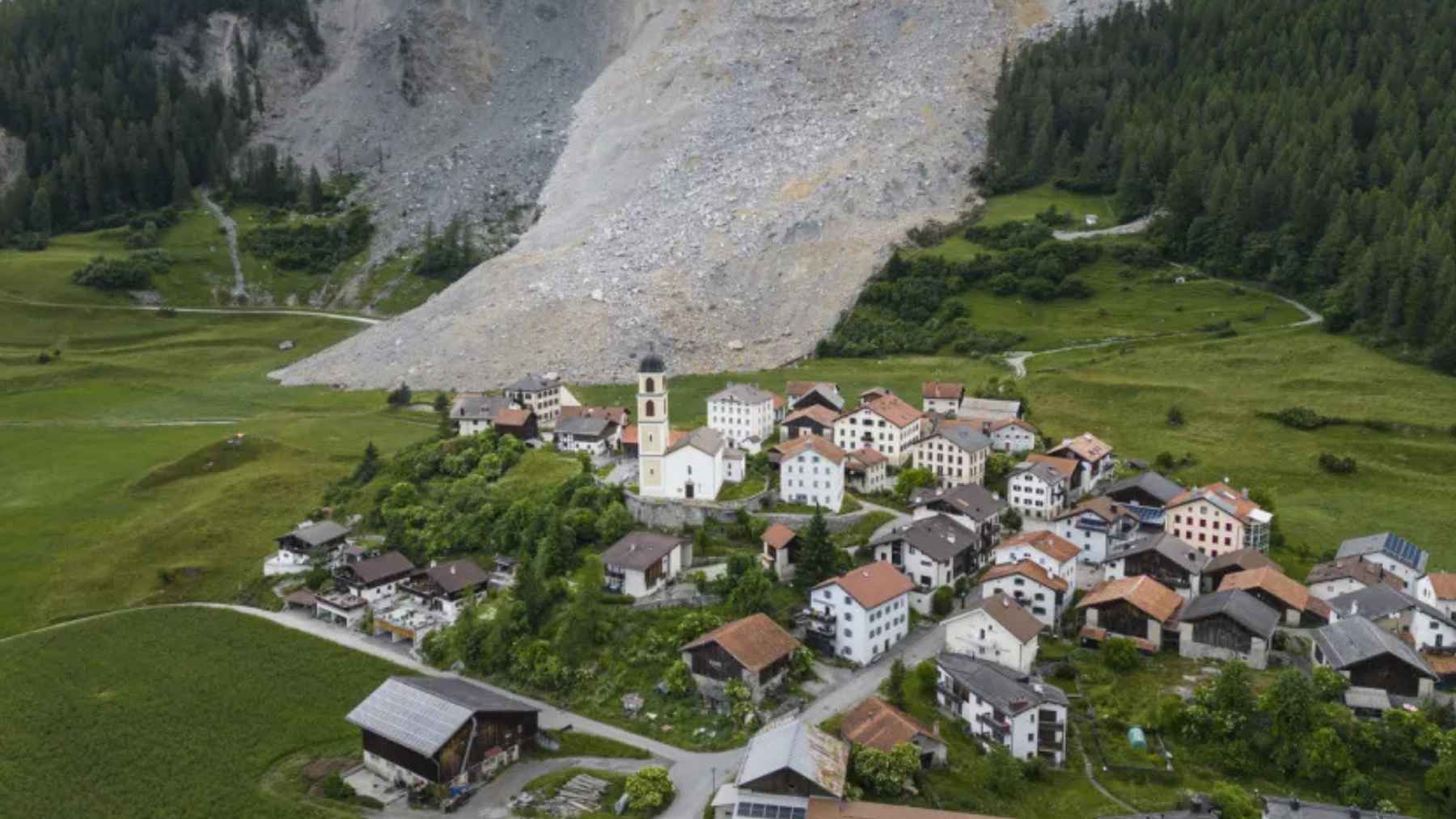 Aerial view of Sarreyer village in Switzerland beneath a massive landslide that destroyed the Fregnoley bridge and cut off road access