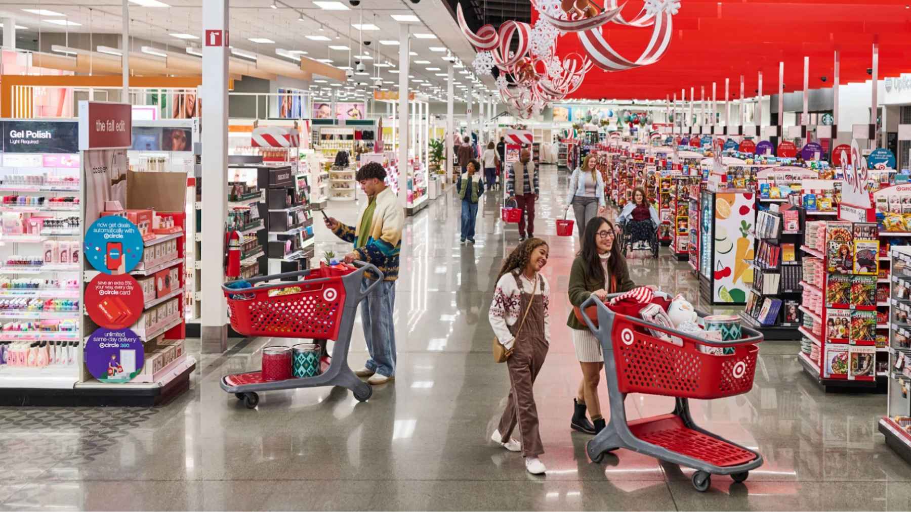 Target store employee greeting shoppers inside a retail aisle as part of a new customer service policy.
