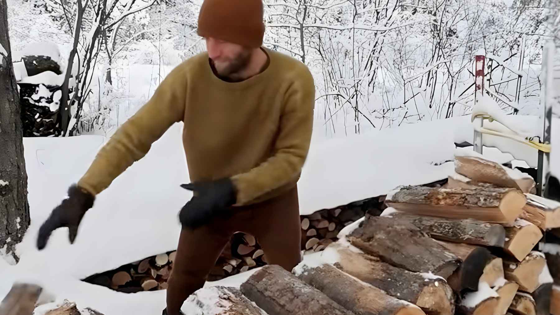 Man living in an uninsulated tiny home in winter using heated stones to stay warm