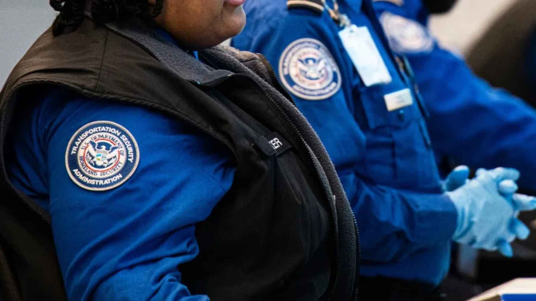 TSA officers at airport security checkpoint during staffing shortages caused by Homeland Security shutdown