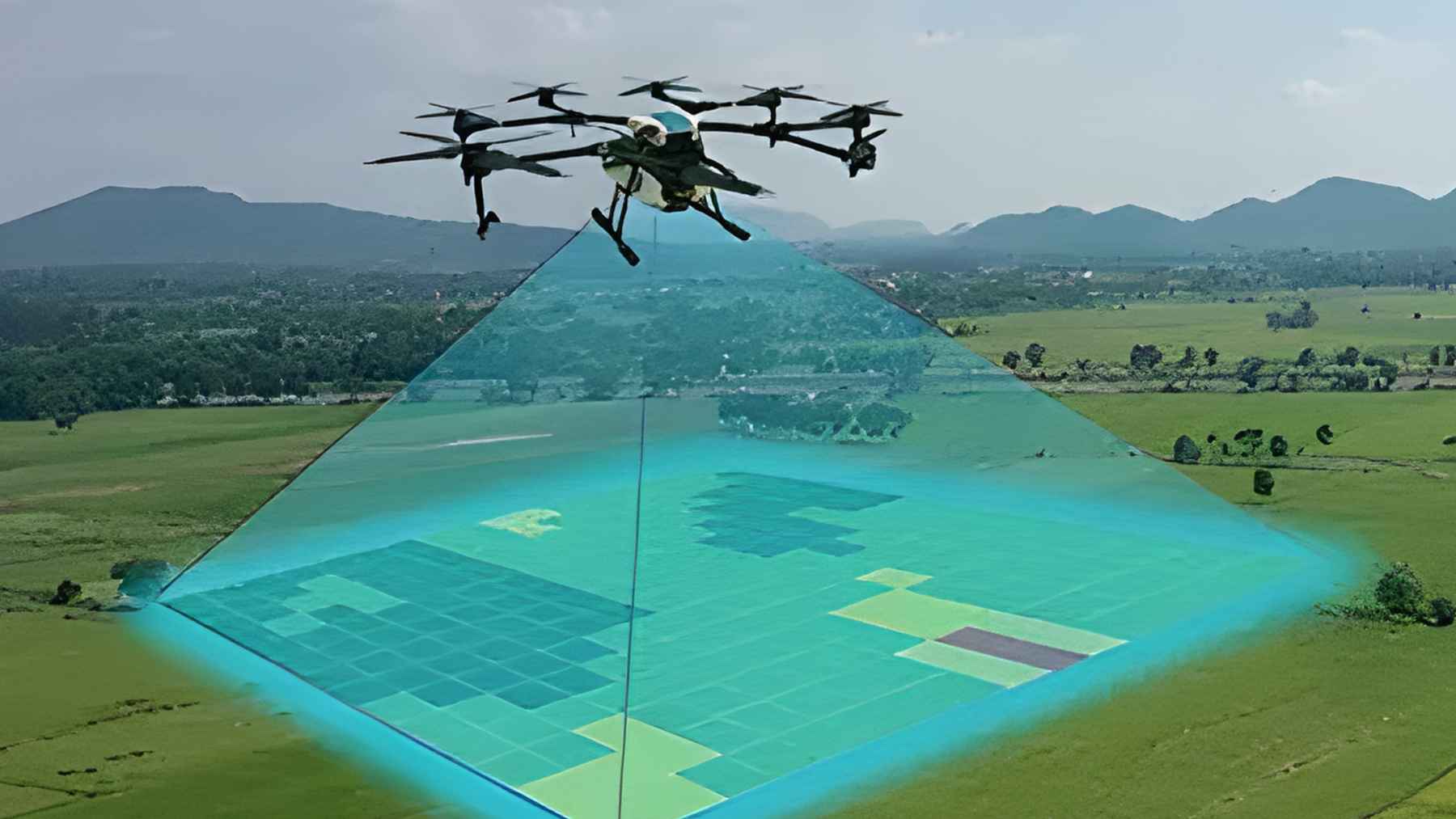 A multi-rotor drone in flight using a blue light sensor beam to scan a green field landscape for surveillance and mapping.