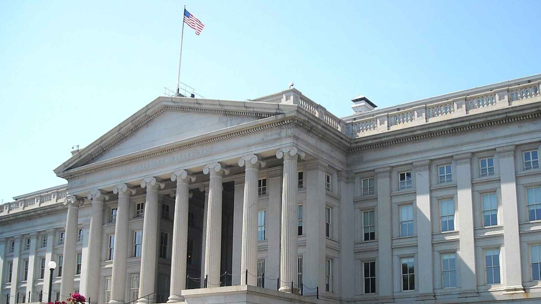 U.S. dollar bills and financial data charts illustrating rising national debt and weekly government borrowing.