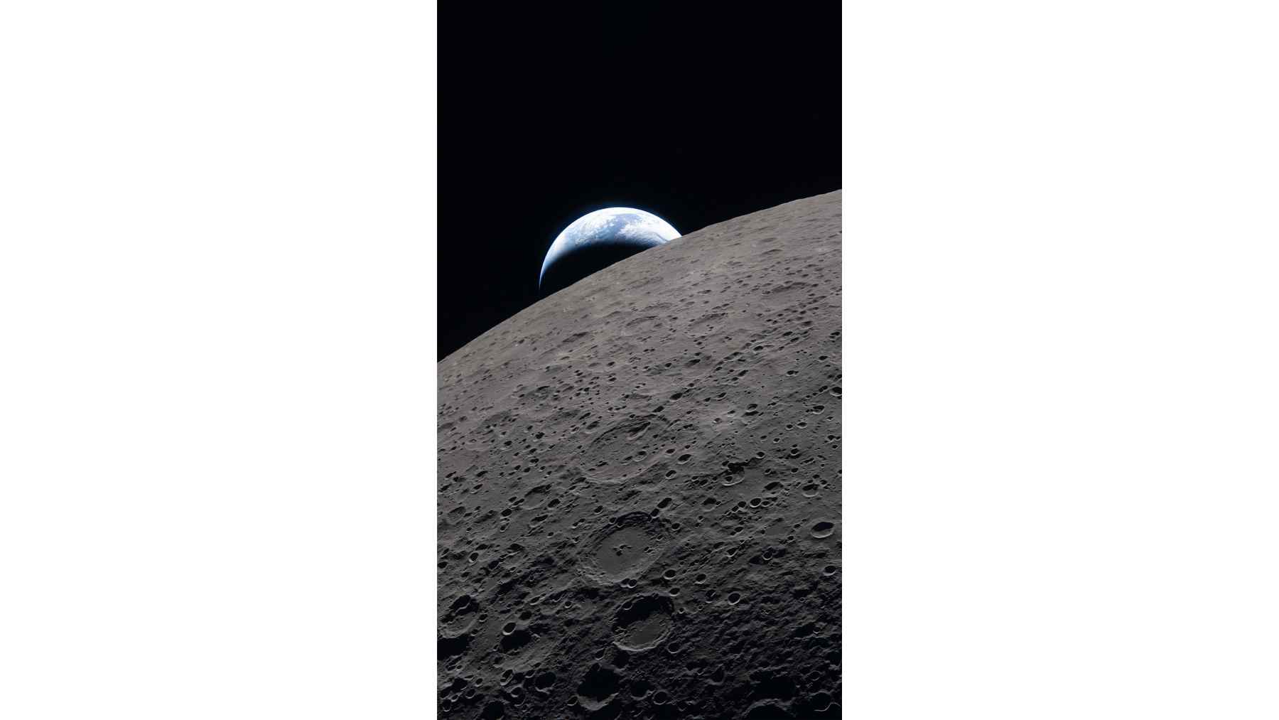 View of Earth rising above the Moon’s cratered surface during the Artemis II mission, captured from lunar orbit.