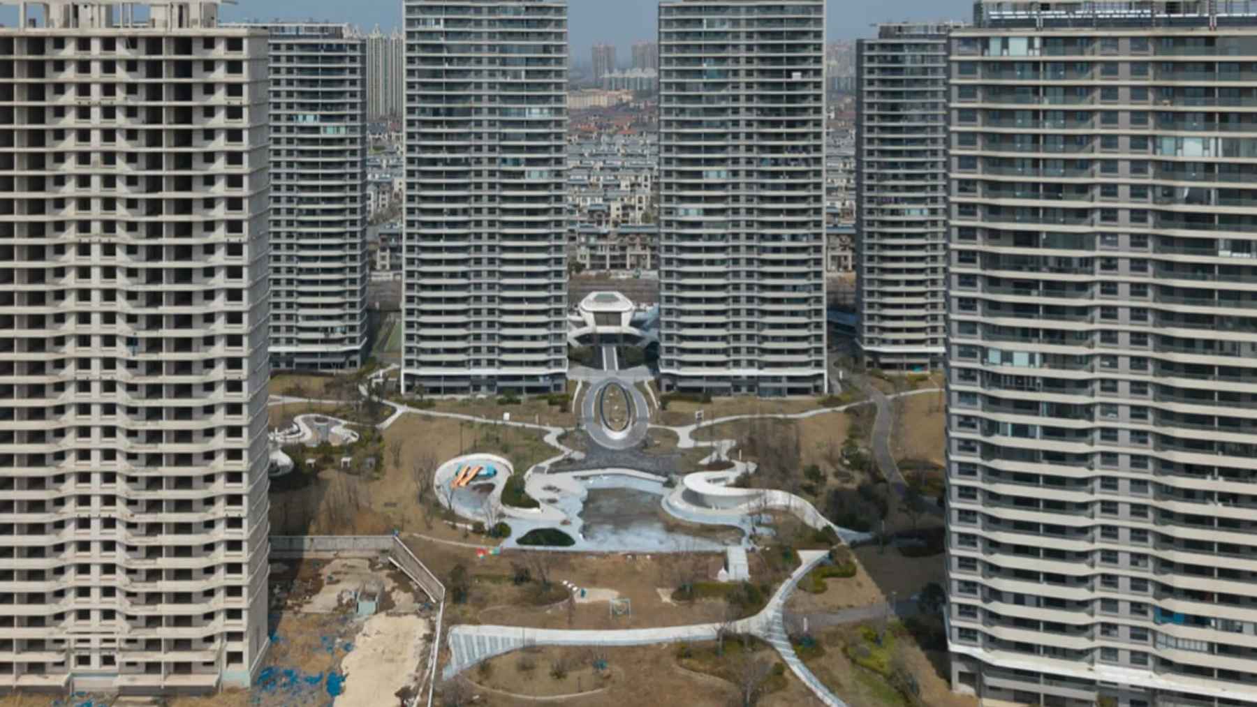 Large residential towers sit partially empty in Qidong, where China’s housing downturn is turning unsold apartments into low-cost retreats for younger renters seeking a slower pace.