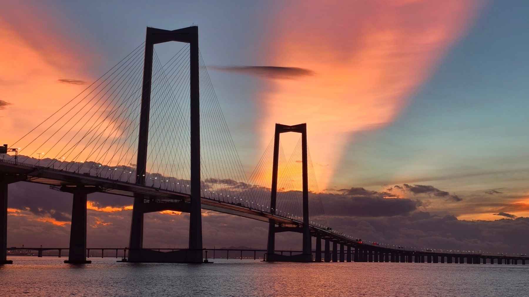 Aerial view of a massive sea-crossing highway in China with bridges and artificial islands connecting major cities
