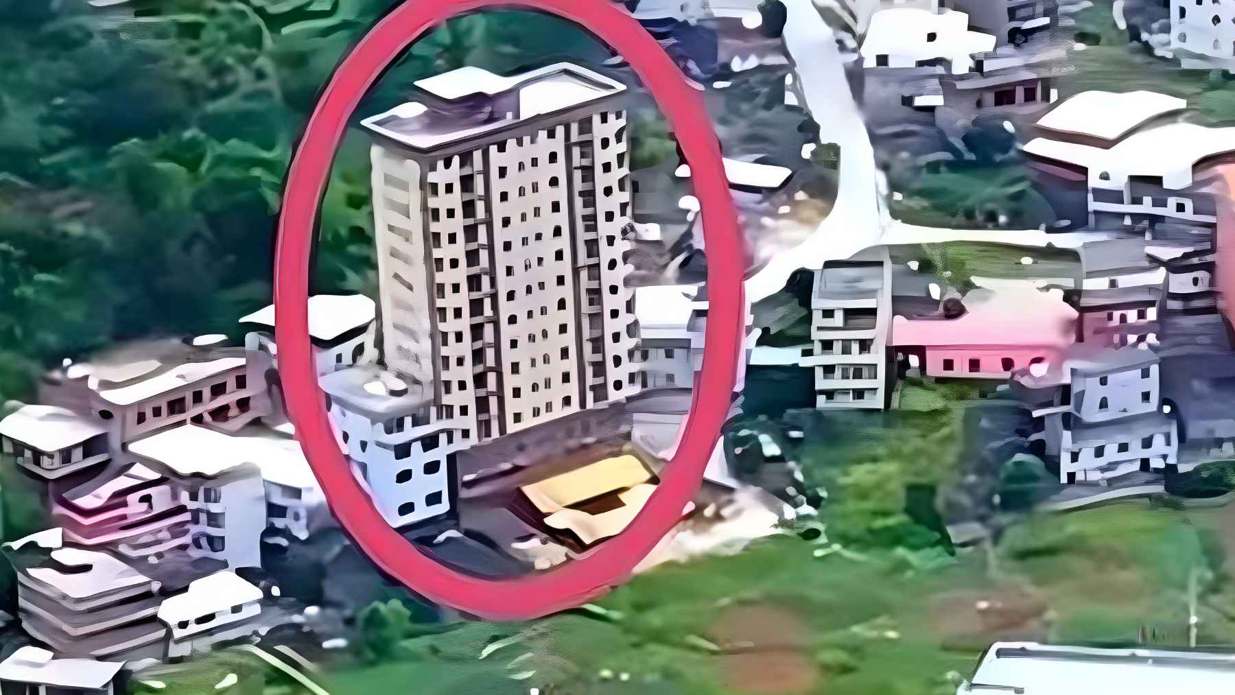Multi-story residential tower in rural Fujian Province built by an extended family, featuring multiple apartments functioning as a vertical village