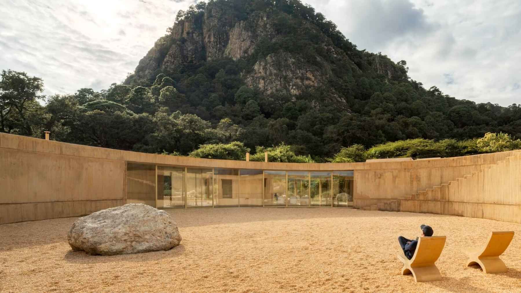 Futuristic sustainable home with circular architecture, solar panels, and integrated natural landscape in Mexico