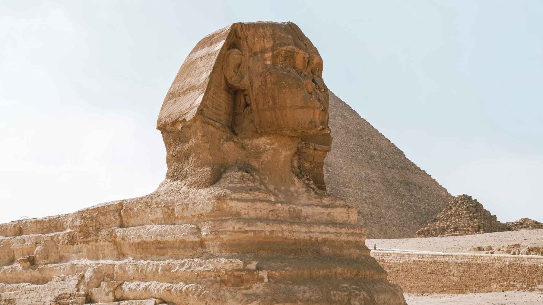 View of the Great Sphinx of Giza and surrounding desert terrain on the Giza Plateau