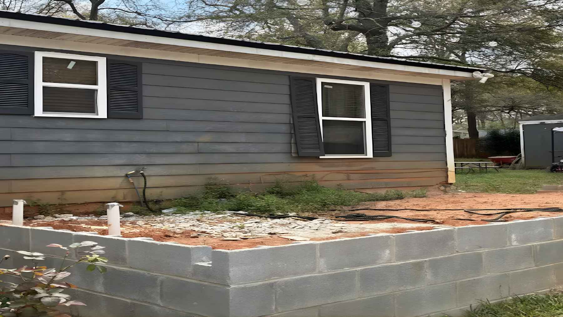 Cracked residential driveway and unfinished home addition after contractor abandoned renovation project