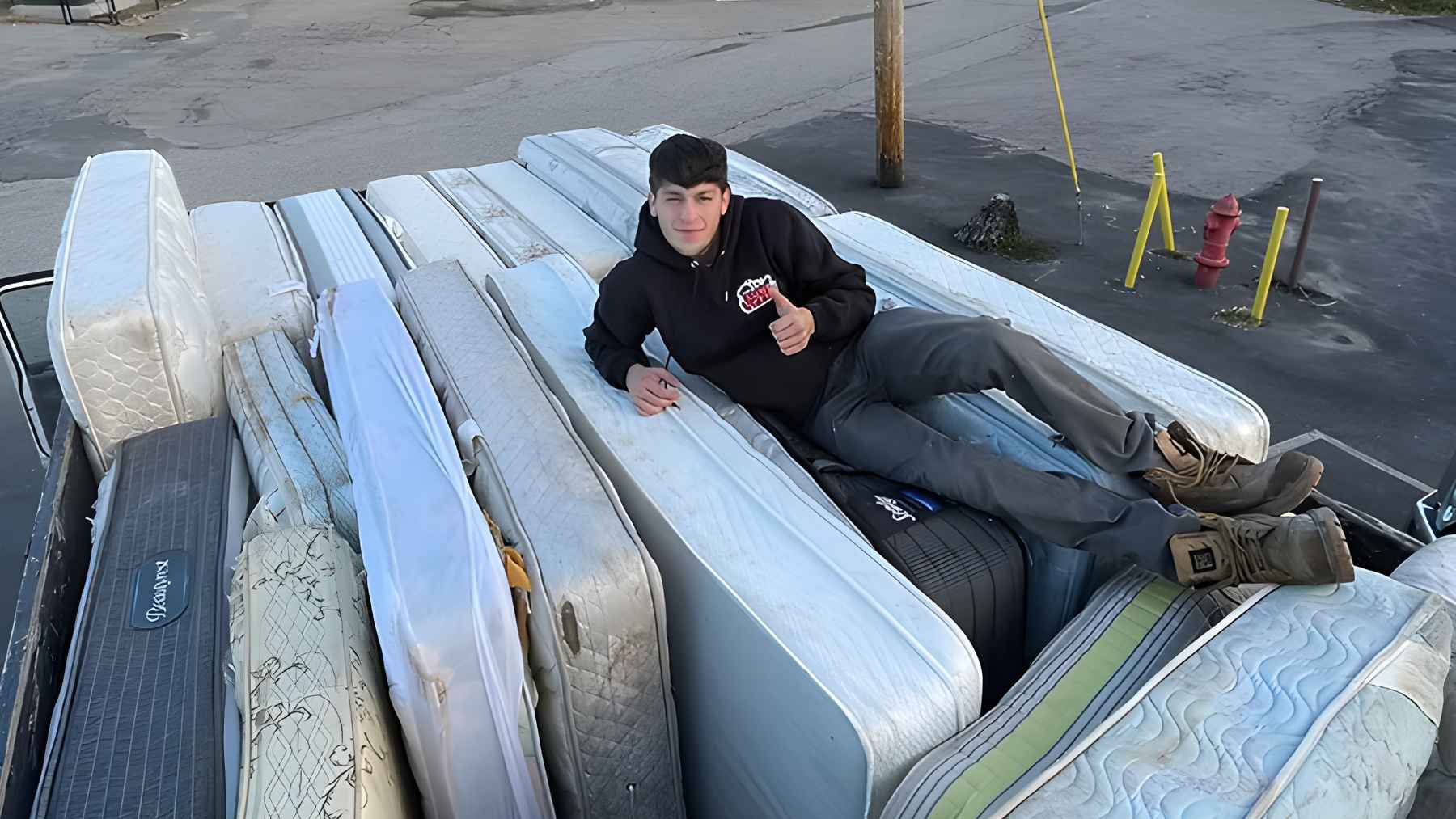 Junk removal workers loading items into a dump truck during a residential cleanout job