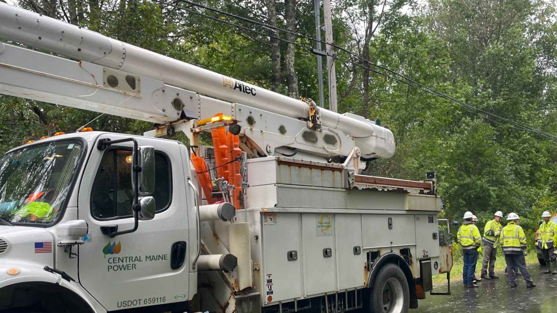 Single-family home with backyard deck and visible power lines, representing residential electricity use and energy costs