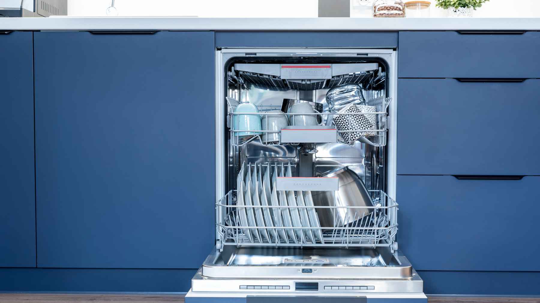 Over-sink dish rack installed above a kitchen sink to save counter space and improve organization