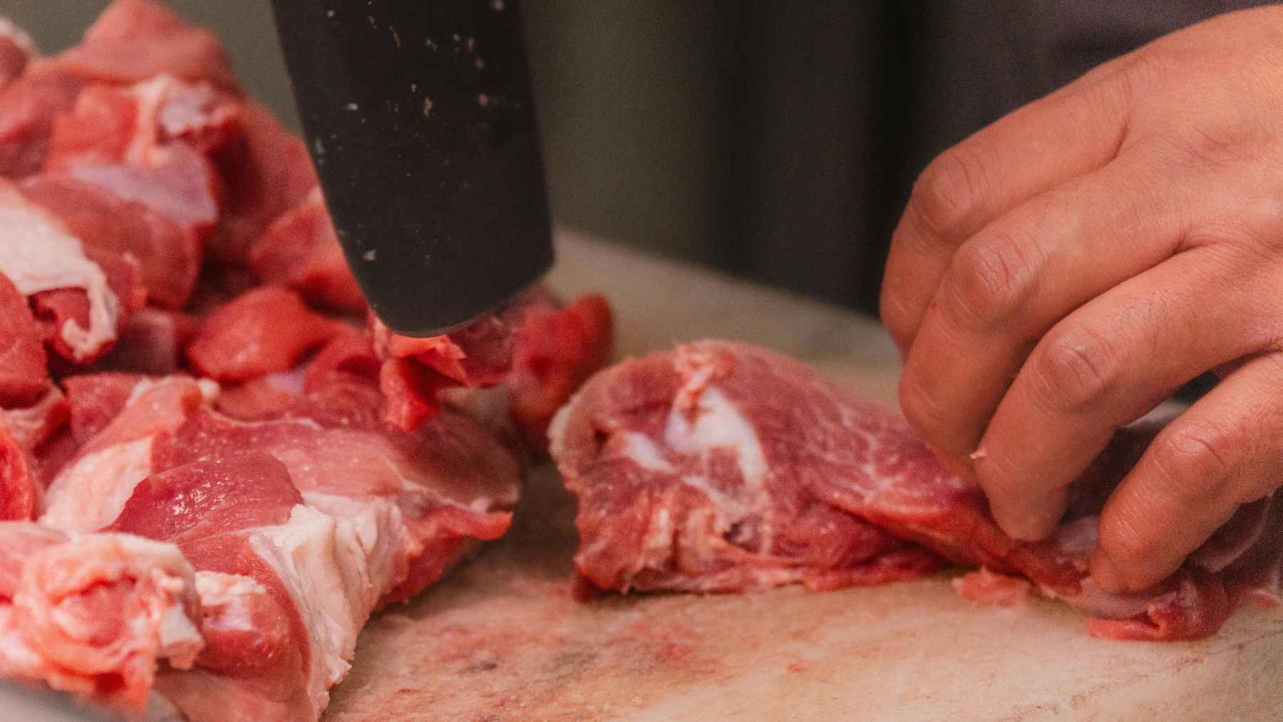 Raw meat stored in a plastic bag inside a refrigerator with moisture buildup and limited airflow