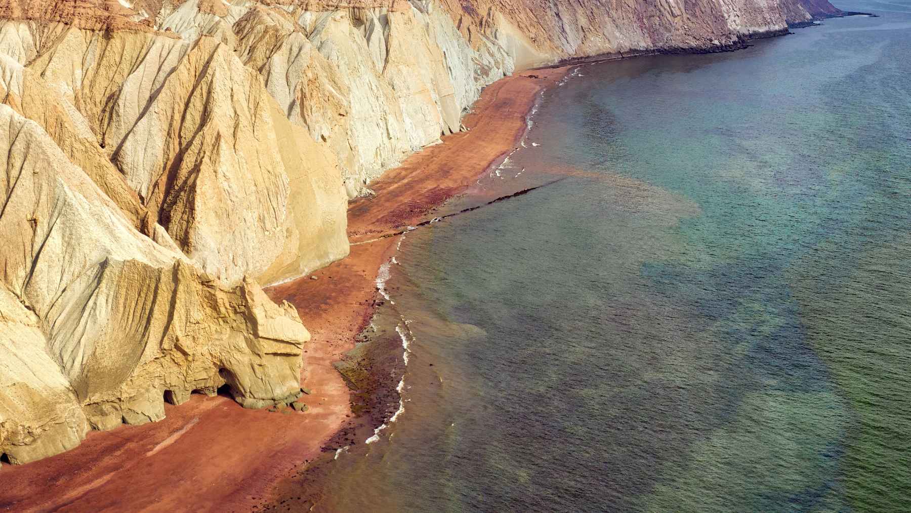 Oil tankers navigating the Strait of Hormuz as regional tensions disrupt global energy flows and impact export revenues.
