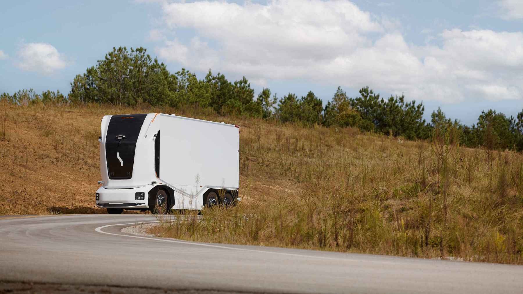 Autonomous semi-truck driving on a high-speed Texas highway, representing the future of driverless freight on SH 130.