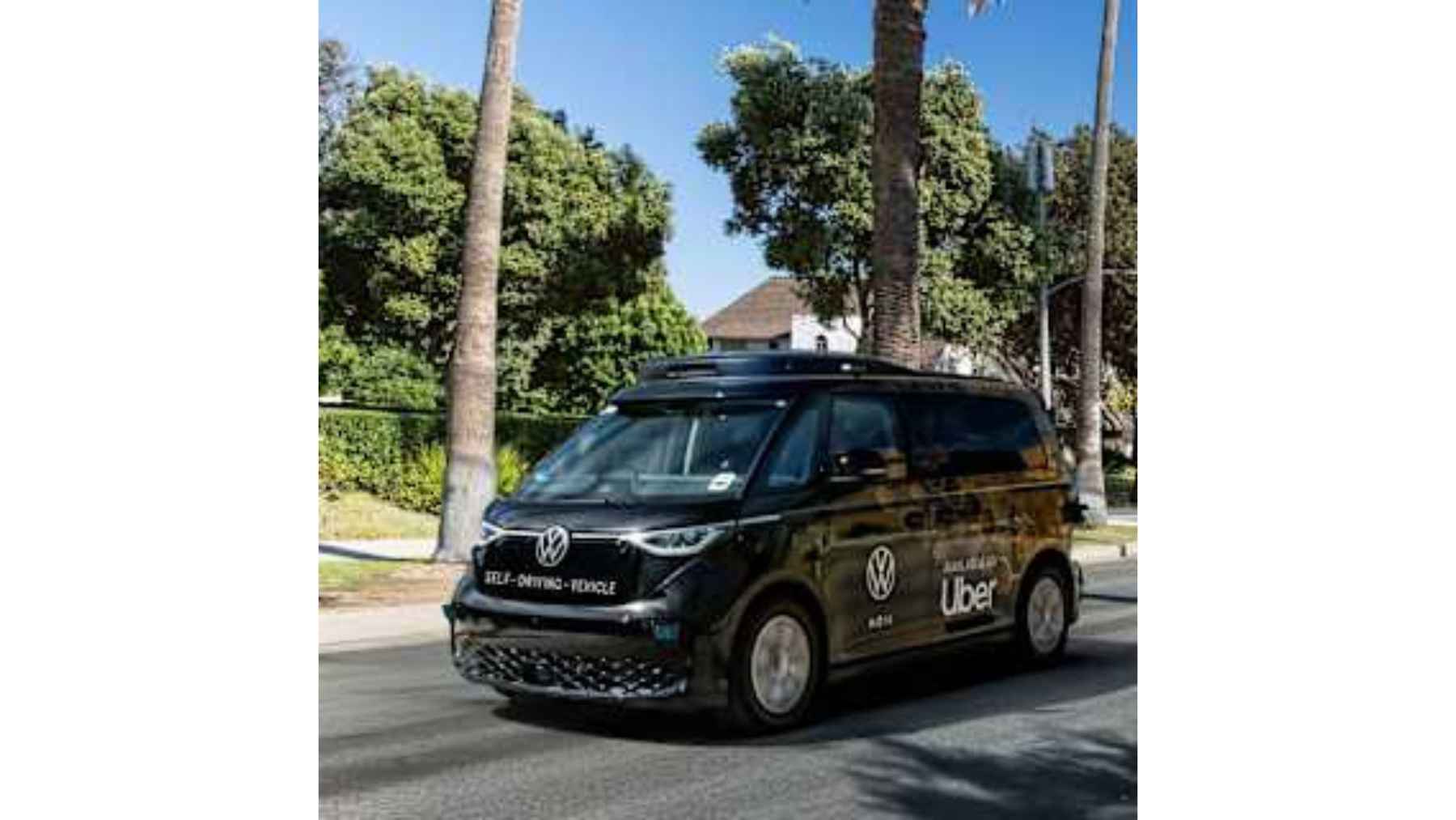 Uber autonomous Volkswagen robotaxi van driving in a city during real-world testing of self-driving technology