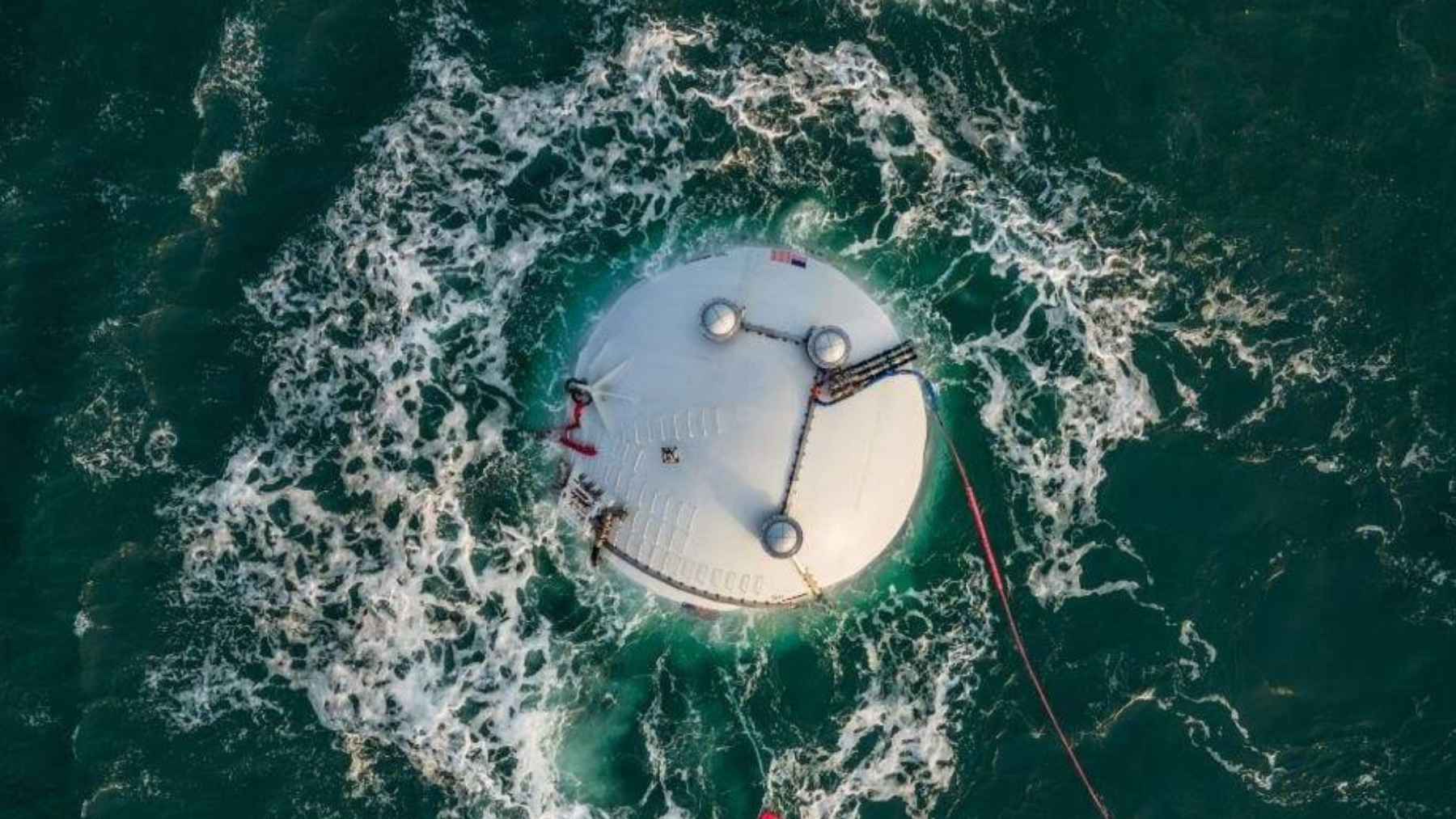Floating spherical wave energy device Ocean-2 in the ocean designed to generate electricity from wave motion