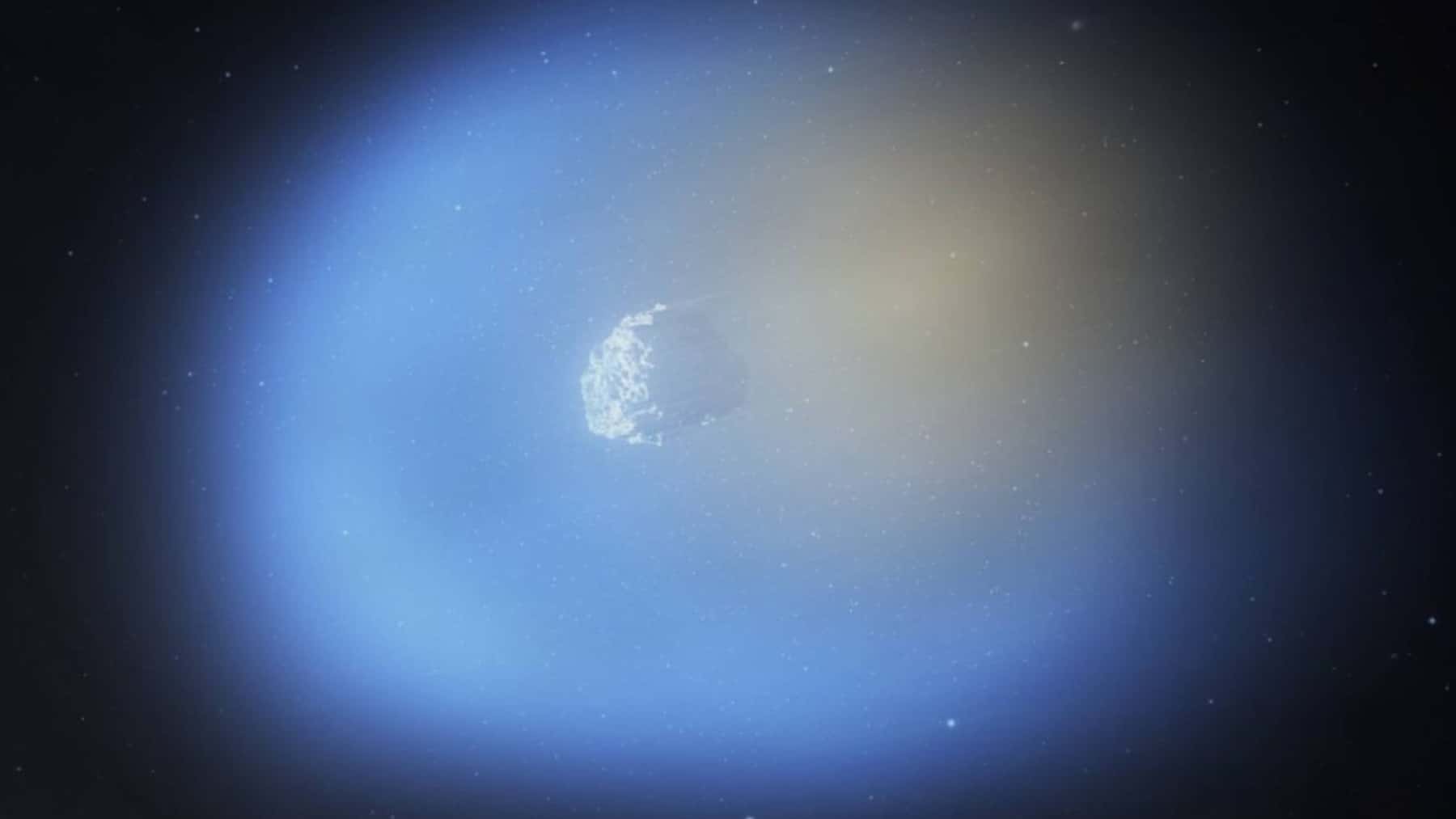 Imagen del cometa 3I/ATLAS en el espacio, rodeado por un halo azulado sobre un fondo estrellado.